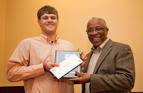 Richard Benjamin of ExxonMobil presents the ExxonMobil Scholarship Award to Austin Clark.