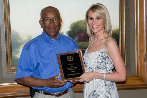 Richard Benjamin (left) of ExxonMobil presents the ExxonMobil Scholarship Award to Meghan Mee, the 2009 outstanding junior in meteorology.