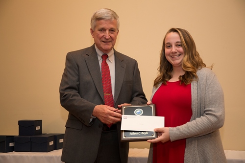 Dr. Bill Williams presents an Outstanding Senior Award to Juliana Bayhi.