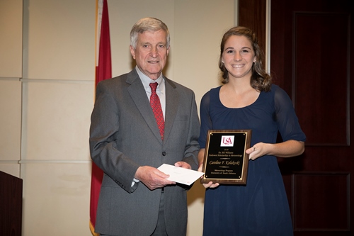 Dr. Bill Williams presents an Endowment Scholarship to Caroline Kolakoski.