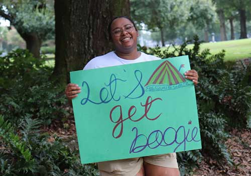 Male Student working on laptop at desk.