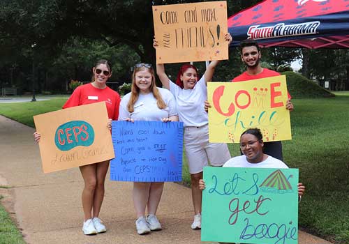 Female student with backpack on walking out of HKS.