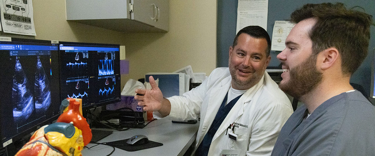 Christopher M. Malozzi, D.O., meets with a medical student from the Whiddon College of Medicine.