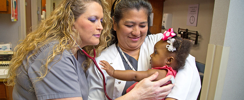 Two nurses taking care of baby