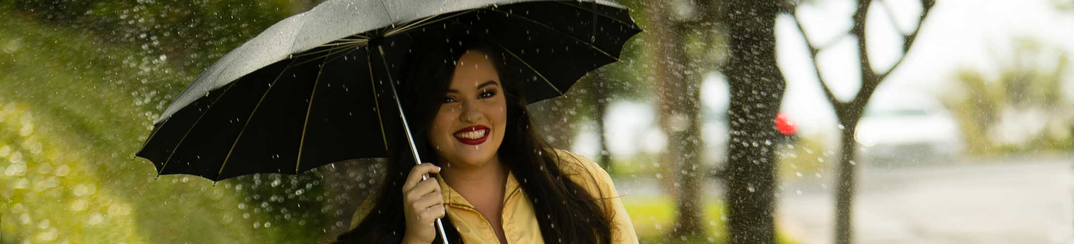 student holding umbrella in the rain