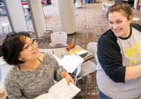 A staff member working with a student in Academic Excellence.