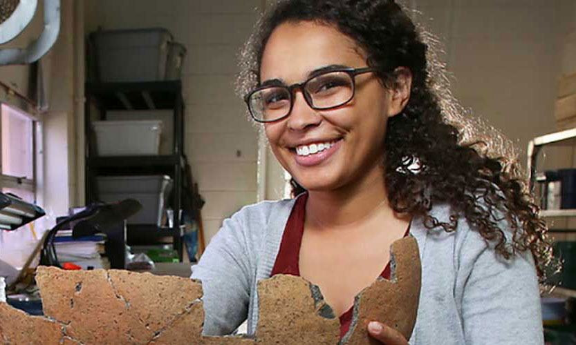 Anthropology student with artifact