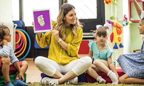 A student teacher working with a child.