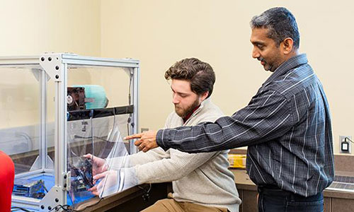 Electrical Engineering student working with professor on project.