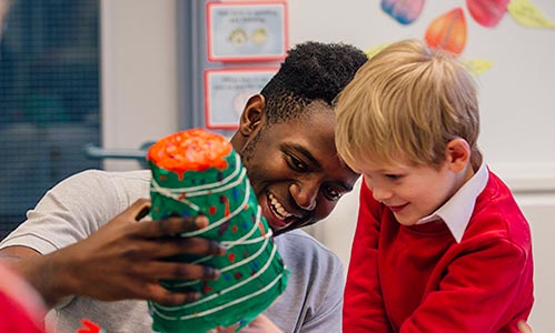 teacher showing an item to a student