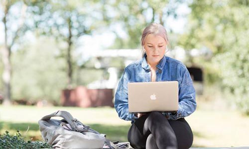Student smiling with laptop