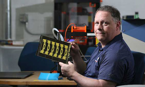 Professor working on technology equipment