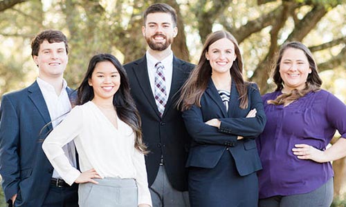 Business student outside smiling.