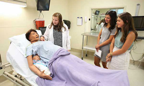 Nursing student working with mannequin