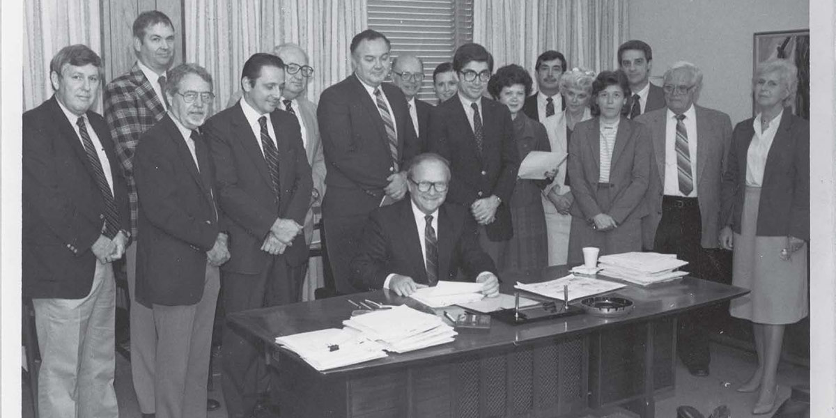 A PHOTO FROM 1985, shows then President Frederick P. Whiddon, seated, in his office. data-lightbox='featured'
