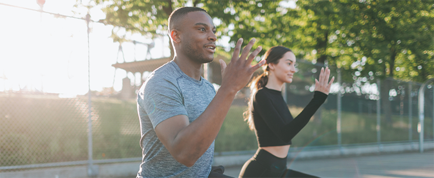 Two people exercising outside.