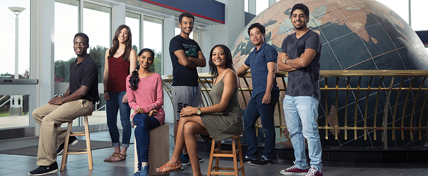 International Students in front of the Waterman Globe in the Mitchell Center