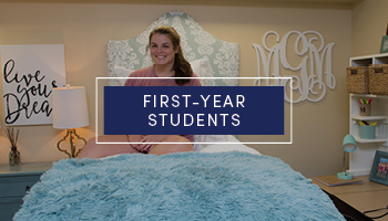 Female student sitting in her bed in her dorm