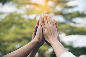 Diverse hands together in the sky