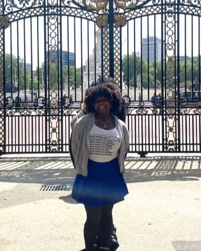 Woman standing in front of gates