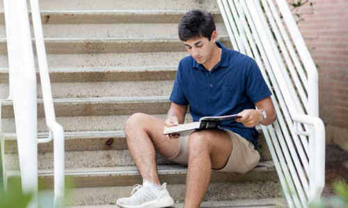 student studying on stairs